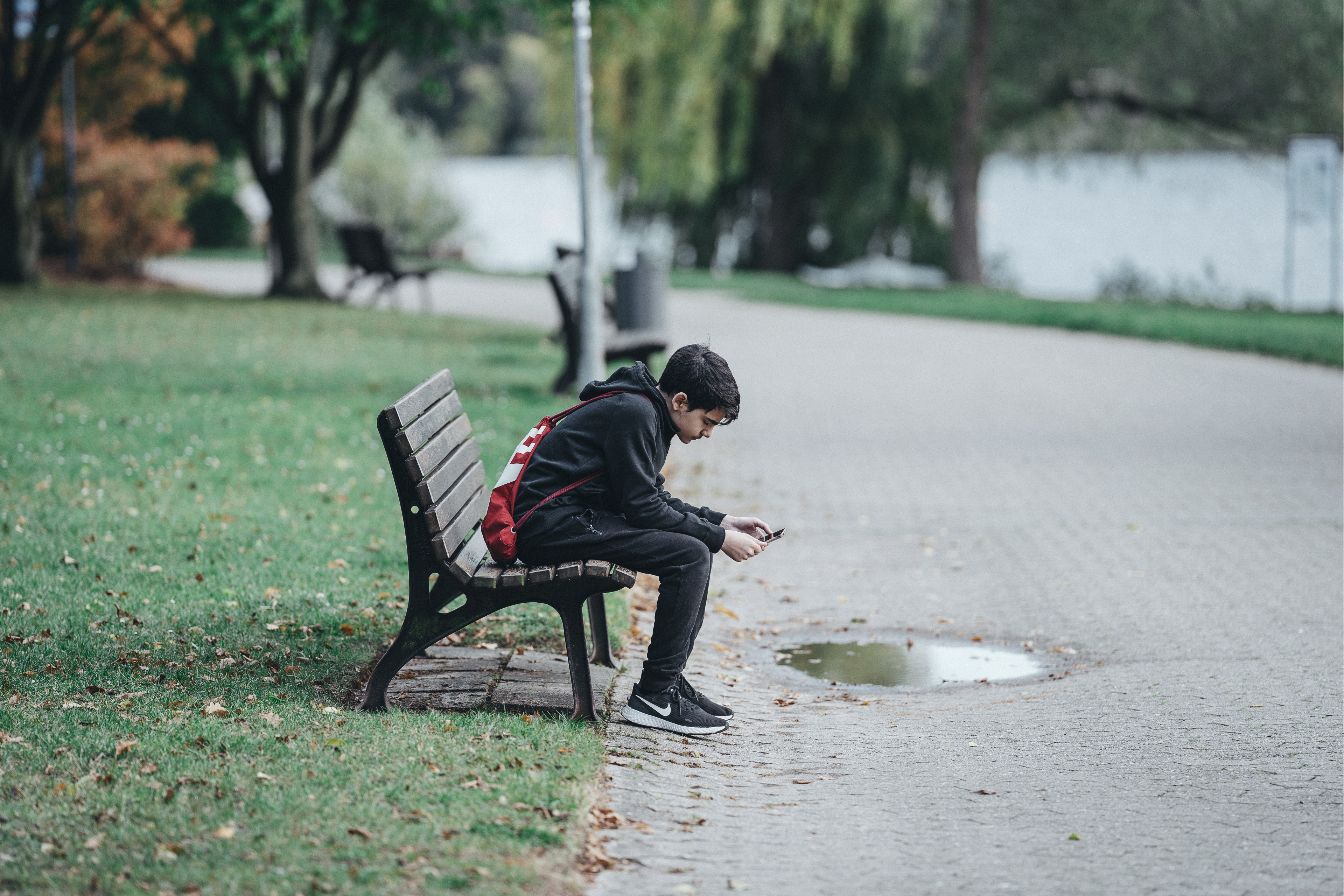 Boy Sat on Park Bench