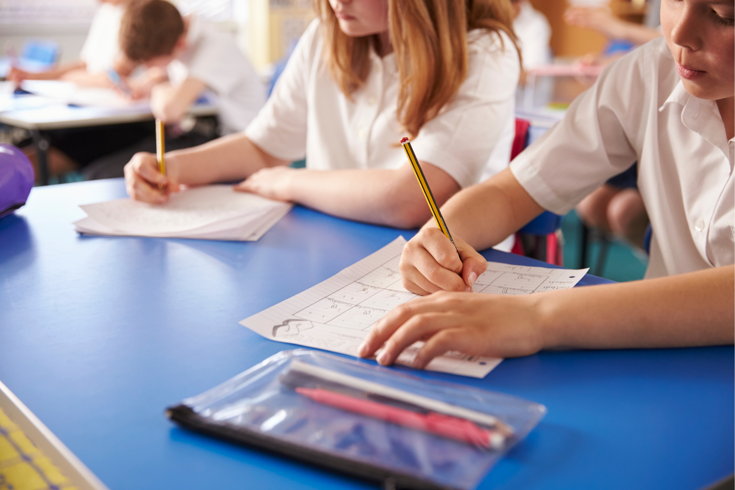Primary School Students Writing on Paper