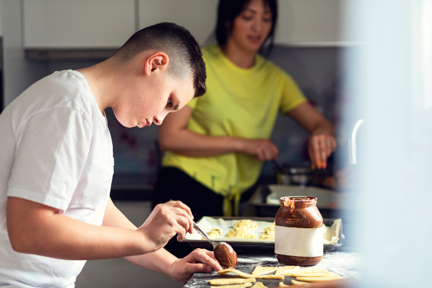Teen boy baking in kitchen